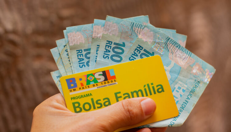 Pessoa segurando cartão do Bolsa Família