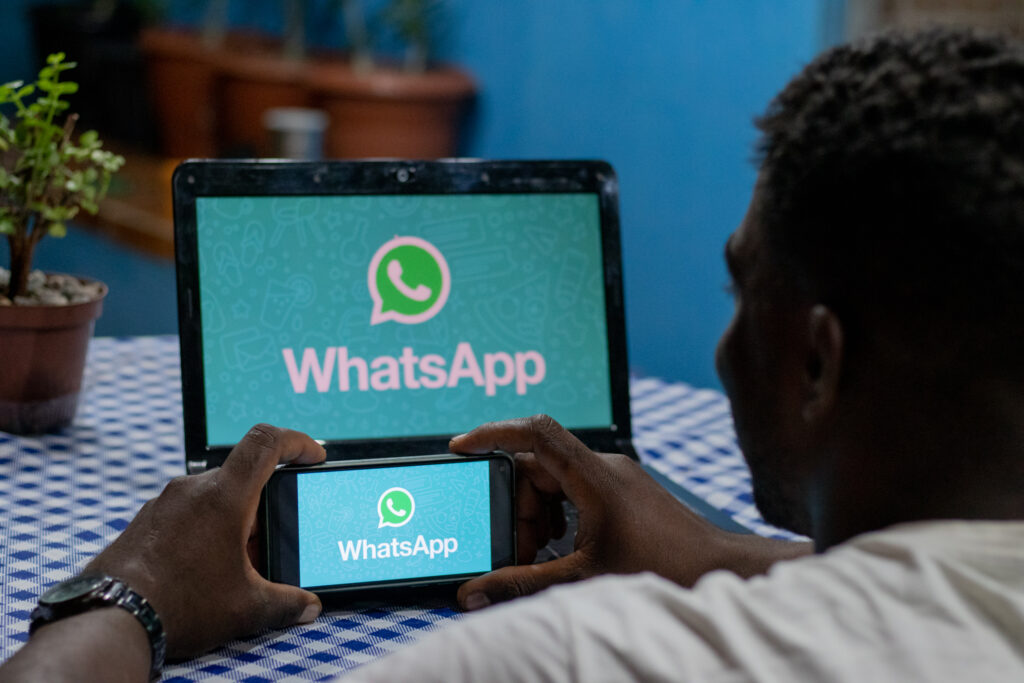Logo na WhatsApp na tela de um notebook e celular.