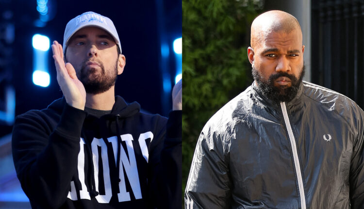Eminem clapping in a black hoodie and cap, and Kanye West in a black jacket, looking serious.