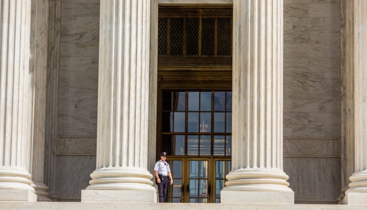 A guard on the Supreme Court steps